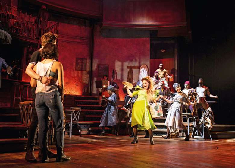 Amber Gray as Persephone (in green) and the company of Hadestown