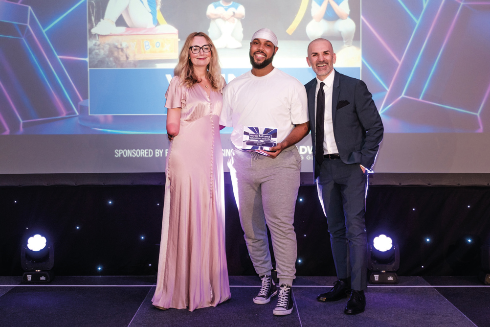 Russeni Fisher receiving his award at the Music & Drama Education Awards 2024